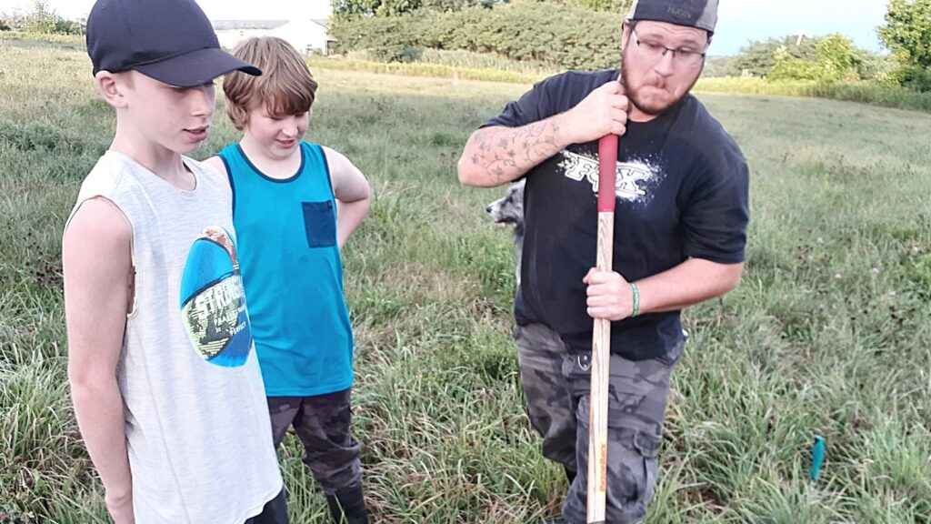 Jon and the kids breaking ground at our market garden site 2020